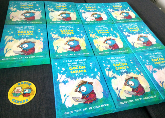 Photo of all 11 speaker gift paintings. Gopher with laptop under the tree.